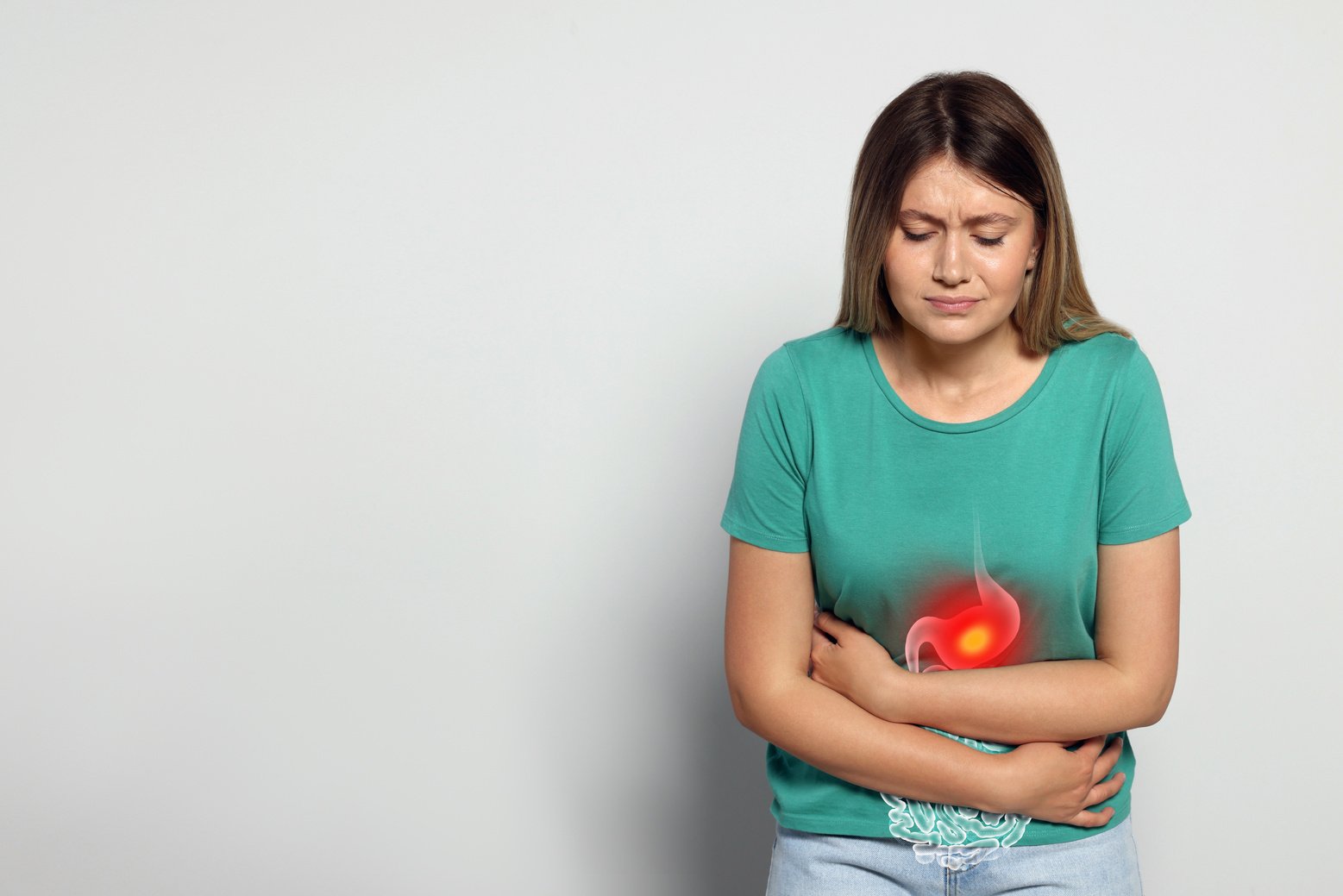 Young Woman Suffering from Menstrual Pain on Grey Background